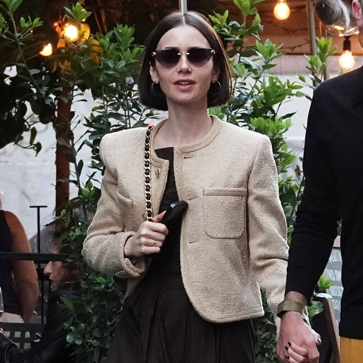 Lily Collins wearing a tan tweed jacket out to dinner in Rome