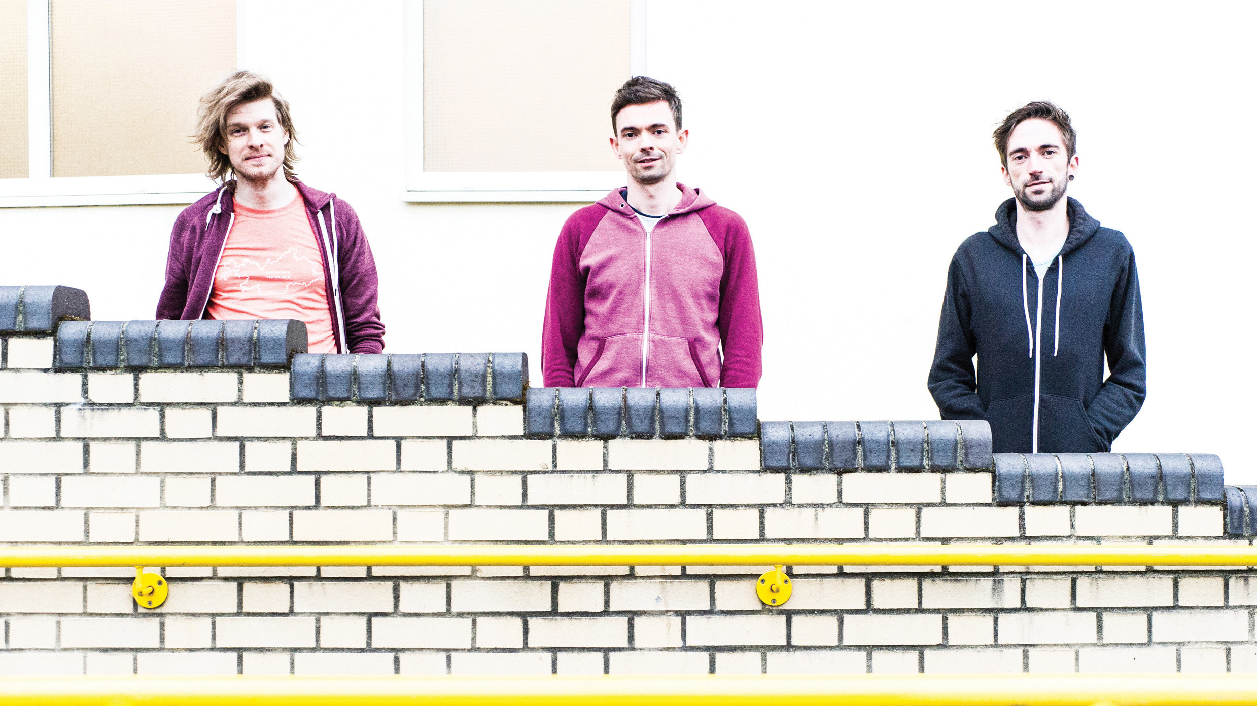 TTNG band shot against a cream wall