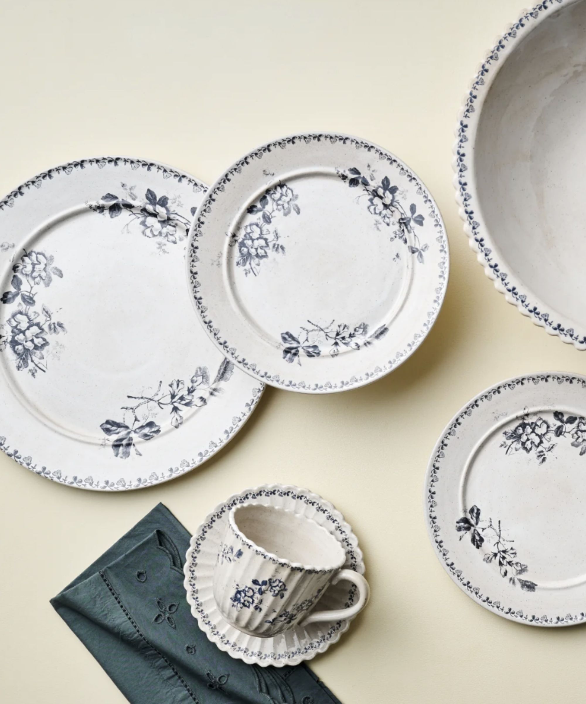 Blue and white floral dinner plates, salad plates and a tea set, with a blue eyelet napkin