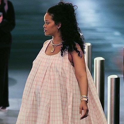 Rihanna wears a Loewe trapeze dress with a necklace stack and pink ballet sneakers