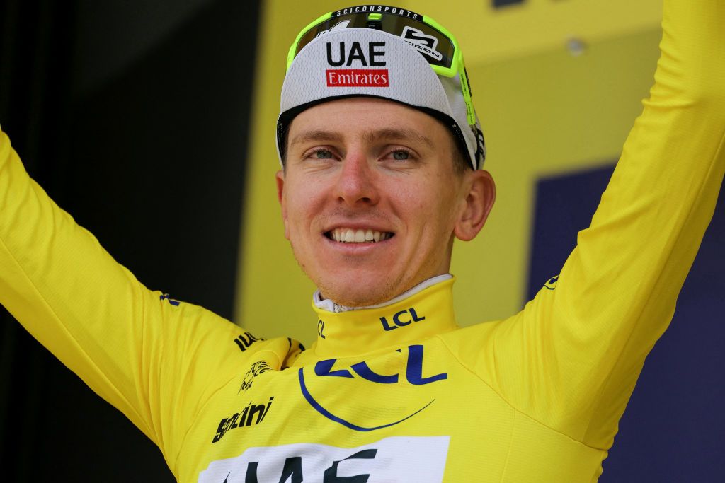 UAE Team Emirates team's Slovenian rider Tadej Pogacar celebrates on the podium with the overall leader's yellow jersey after the 4th stage of the 111th edition of the Tour de France cycling race, 140 km between Pinerolo in Italy, and Valloire in France, on July 2, 2024. (Photo by Thomas SAMSON / AFP)