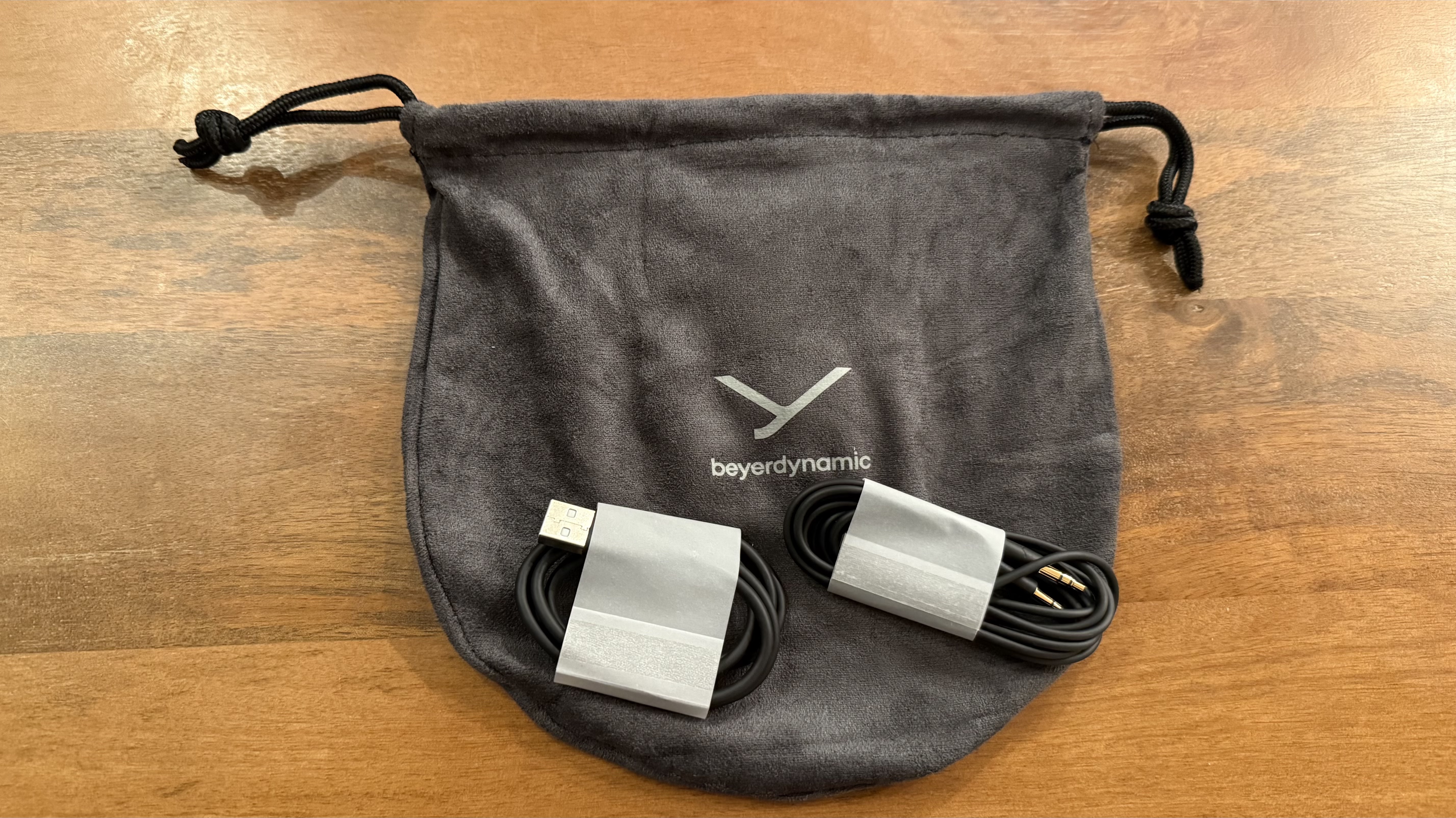 Beyerdynamic Aventho 100 headphones on a wooden table