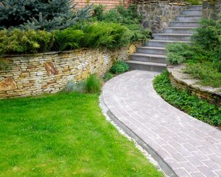 retaining stone wall alongside path and lawn