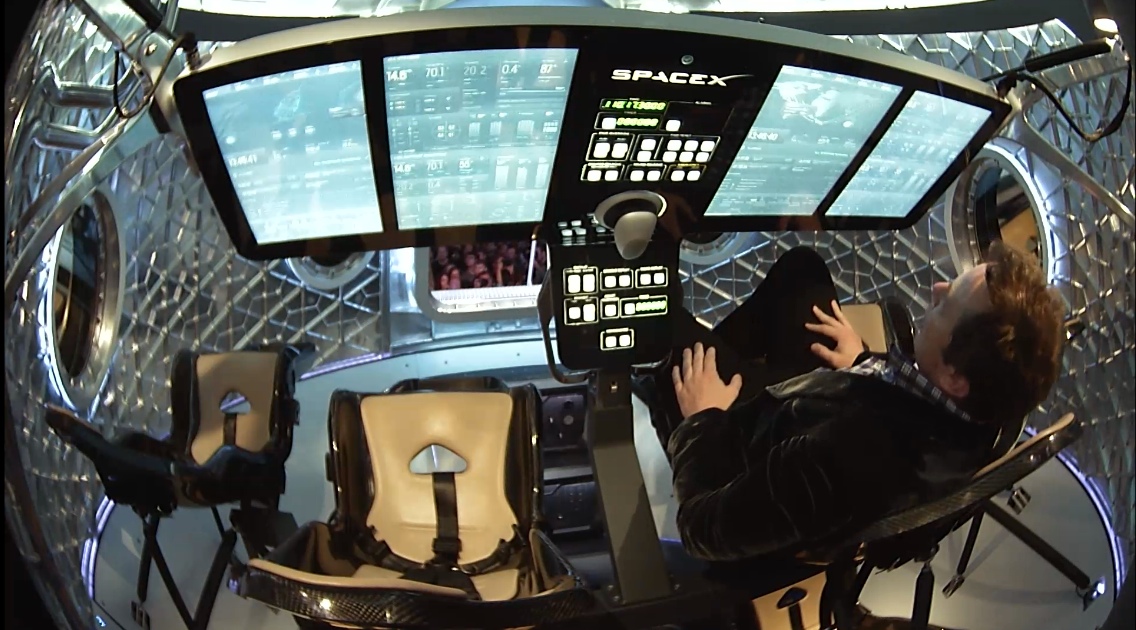 Here, Elon Musk sitting in one of the Dragon V2 capsule's seven seats on May 29, 2014, during a press briefing at the SpaceX headquarters in Hawthorne, California.