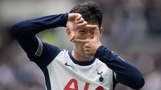 Son Heung-Min does his trademark camera frame celebration, in the blue and white Spurs home kit, after scoring a goal in the Premier League.