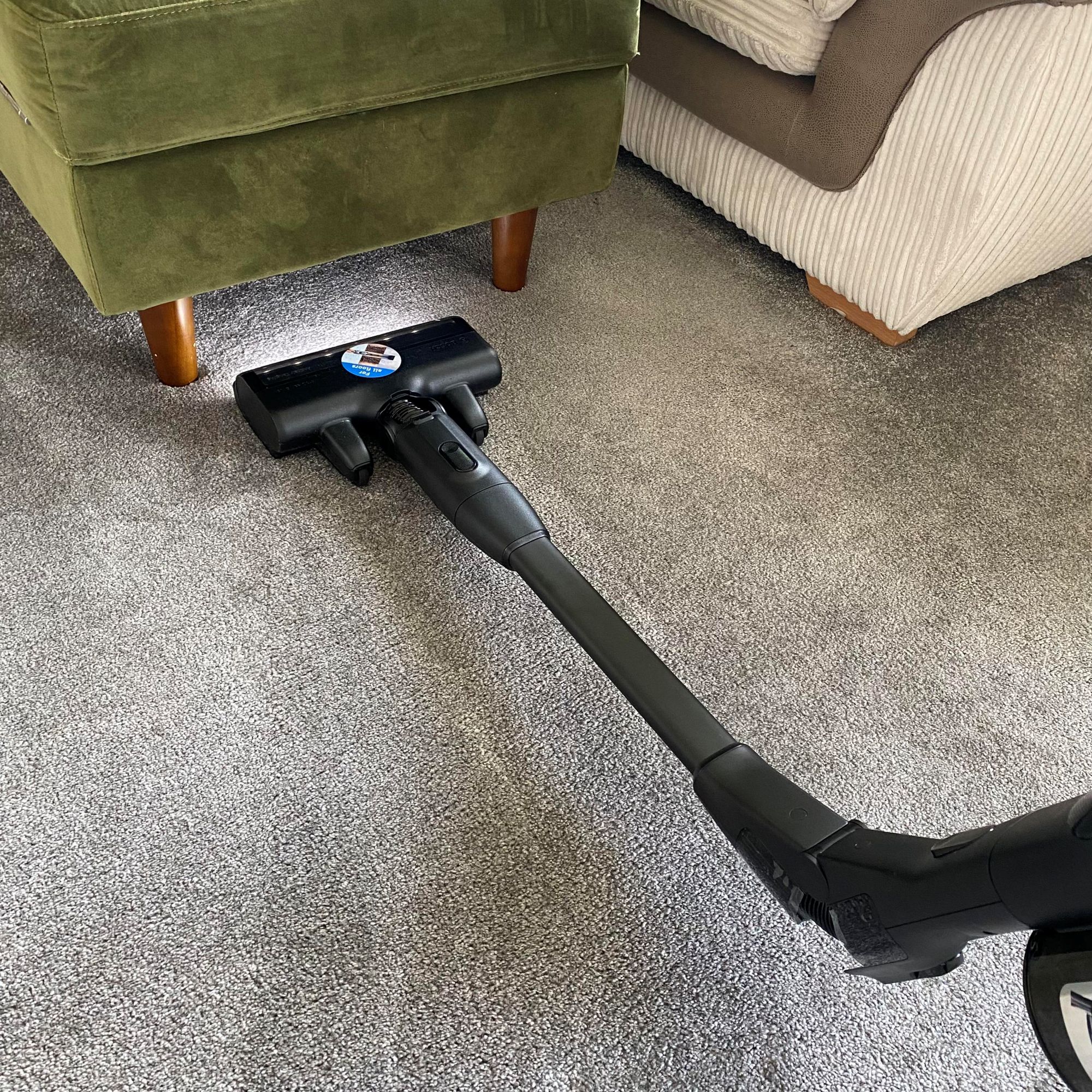 Bosch Unlimited 10 ProPower cordless vacuum cleaning under pouffe