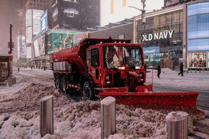 Snowplow clearing New York City streets.