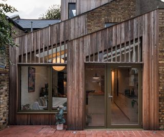 Double pitched roof extension with a treated timber cladding