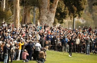 Tiger Woods hits an iron shot at the Genesis Invitational