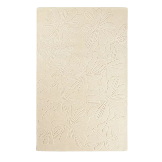 A large floral hand-tufted rug in ivory