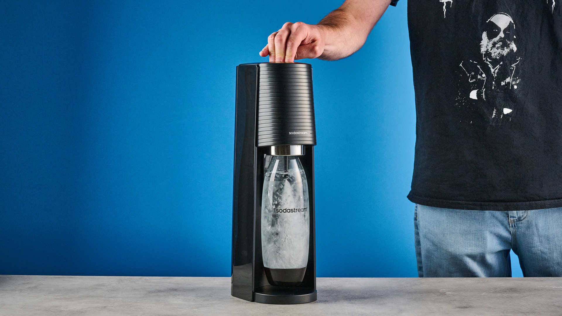 The SodaStream being used against a blue background