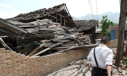 A man walks across rubble caused by an earthquake which hit China's Sichuan Province on April 20, 2013 in Ya'an, Sichuan Province of China.