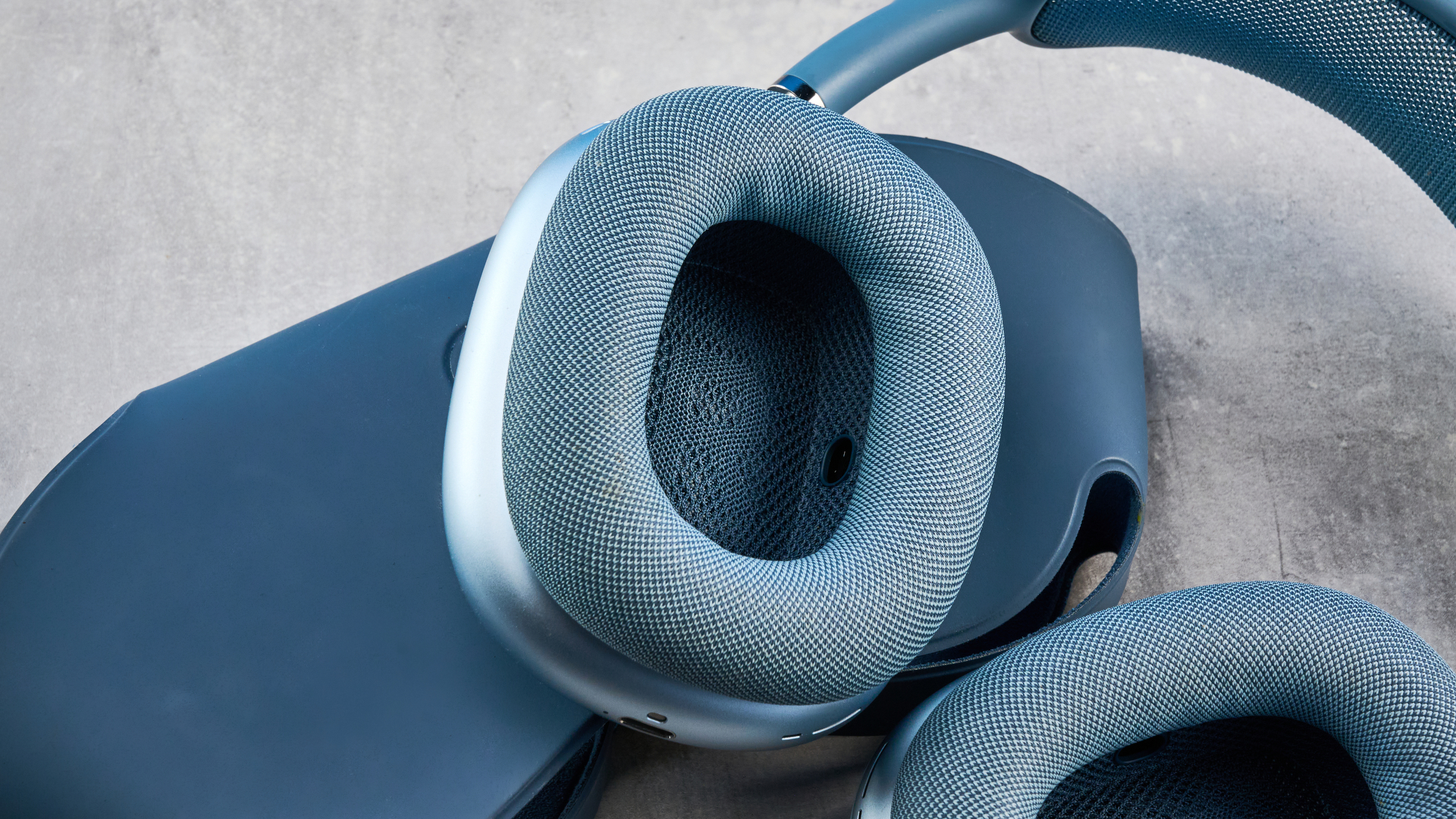 the airpods max (2024 edition) in blue photographed against the blue tom's guide background