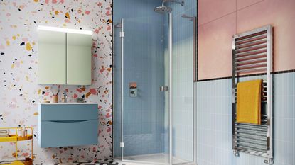 A colorful modern bathroom with blue metro tiling and terrazzo wall tile decor