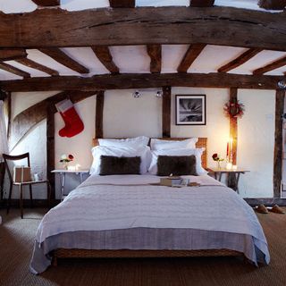 bedroom with white wall and beams