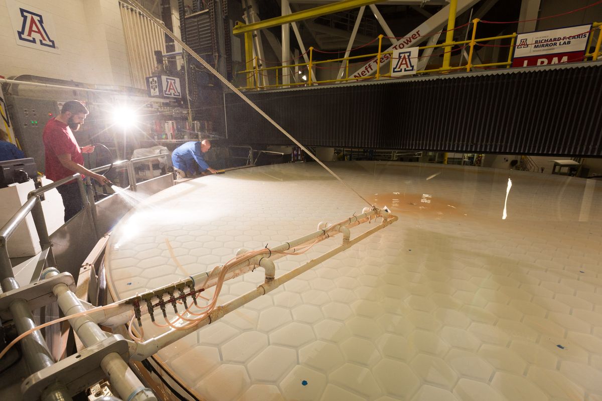 Technicians work on the mirror segment No. 2 for the Giant Magellan Telescope at the University of Arizona&#039;s Richard F. Caris Mirror Lab.