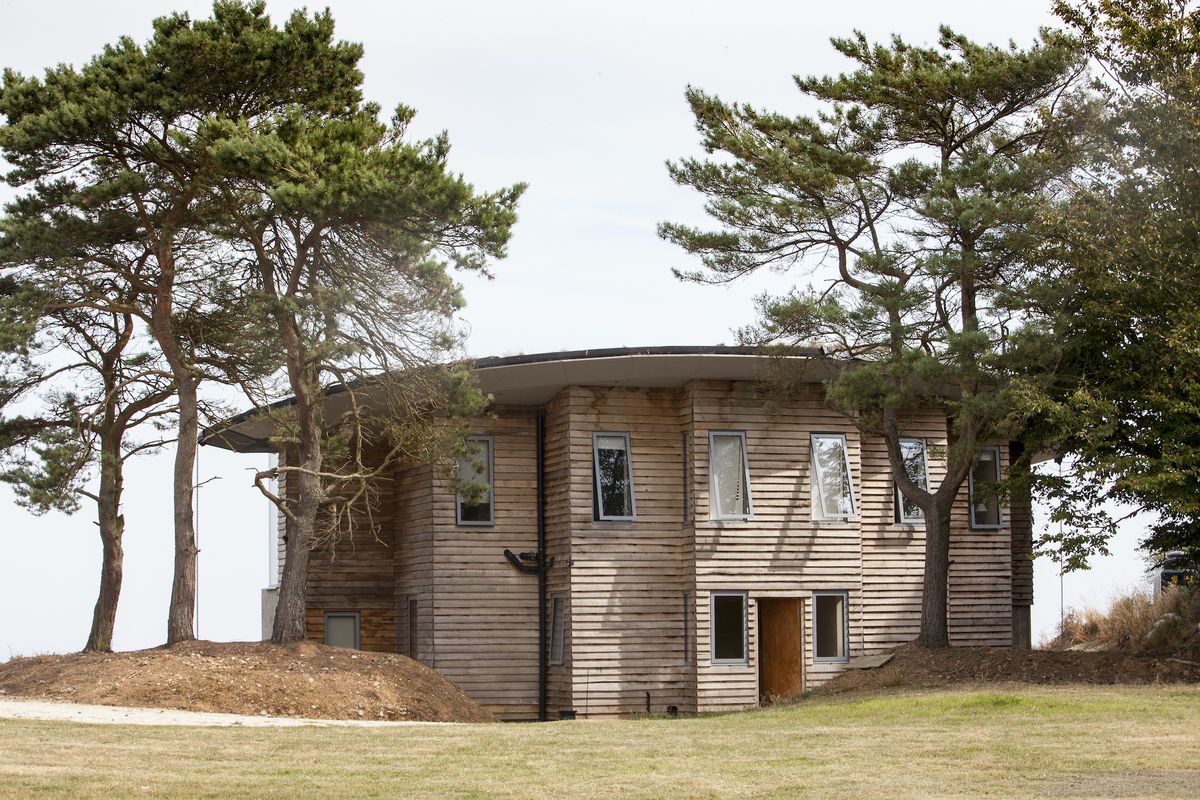 self build home with timber cladding and open plan space and glazing
