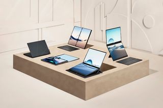A collection of ASUS Zenbook Duo computers in different configurations on a table