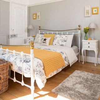 bedroom with grey walls and wooden flooring