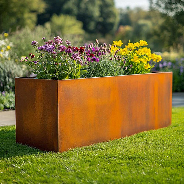 Rectangular corten steel planter filled with plants