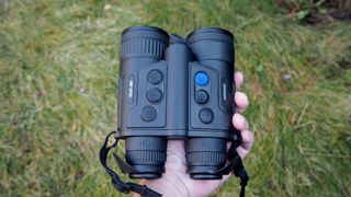 Pulsar Merger LRF XP35 binoculars on a grassy surface