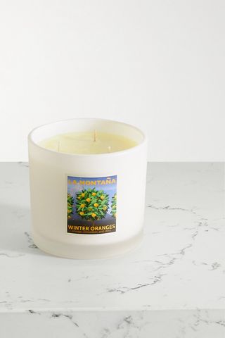 La Montaña Winter Oranges Scented Candle, 650g on a white marble counter with a light gray background 