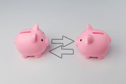 two piggy banks with two arrows in between them pointed in opposite directions