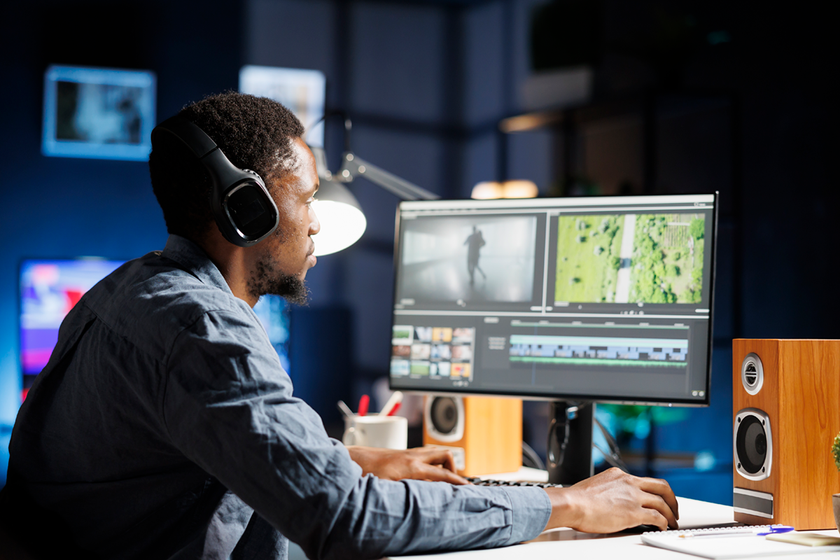 Man looking at computer screen and a video interface. Ross Video