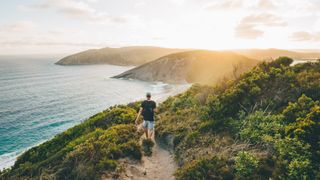 Man hiking on cliffside trail