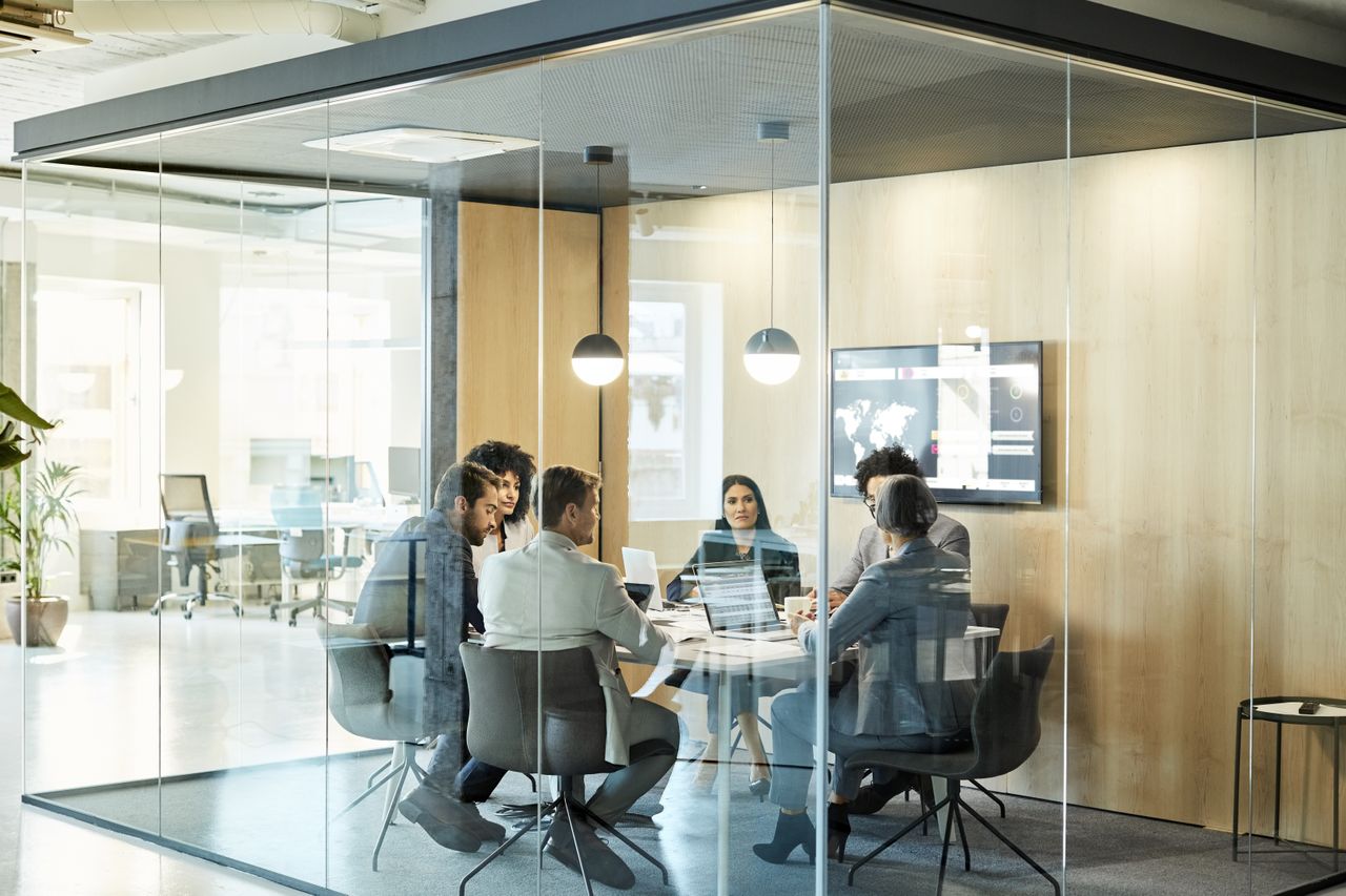 Colleagues sitting around a table in an office