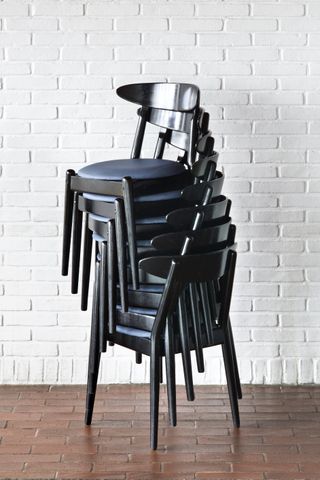 Stack of black chairs on top of each other