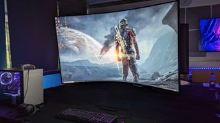 Samsung 55" Odyssey Ark Curved UHD Gaming Monitor showing a video game in a home office