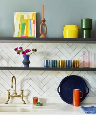 kitchen worktop with white tiles and colourful accessories