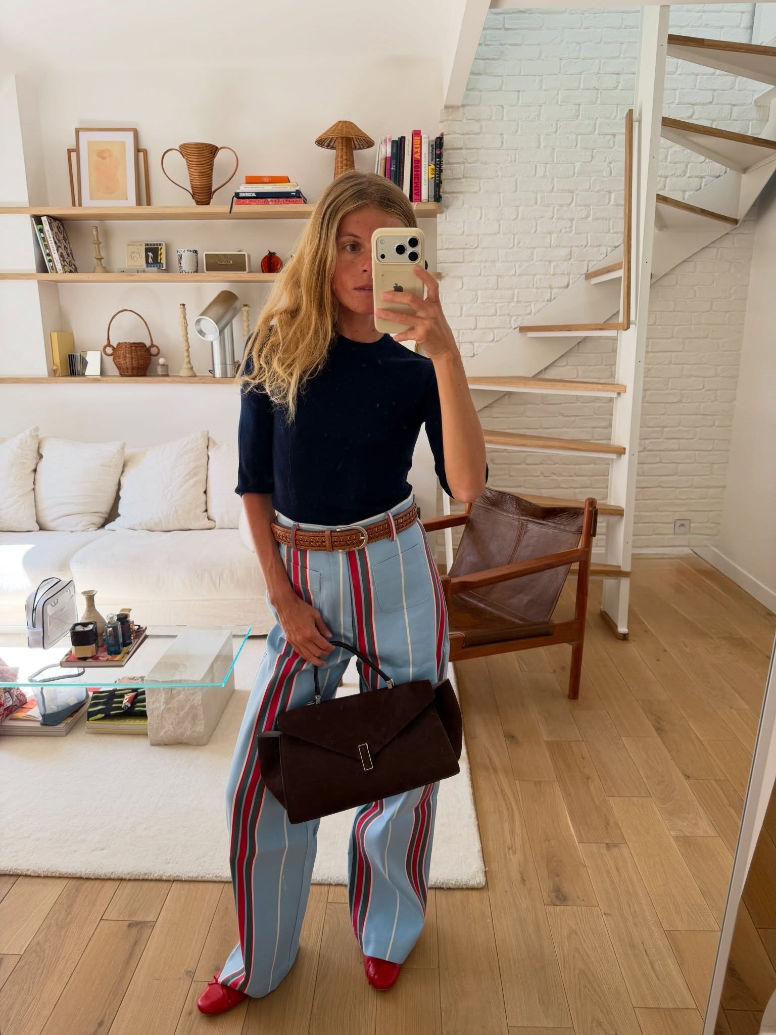 Woman wearing striped jeans, a strong summer 2026 trend.