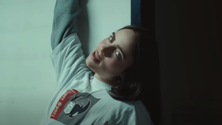 Billie Eilish leaning against a wall in Birds of a Feather music video