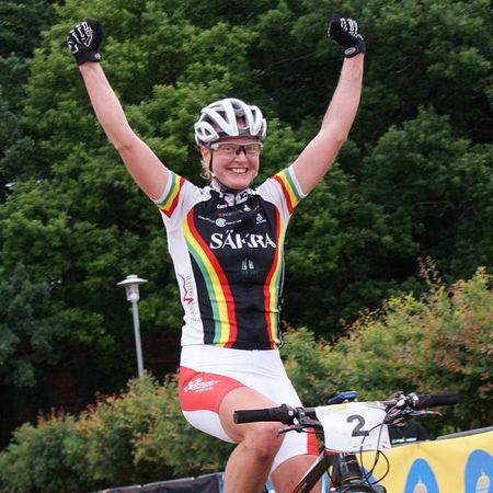 Alexandra Engen raises her arms to celebrate her sixth consecutive championship title