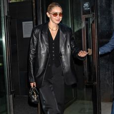 Gigi Hadid wears an all-black suit outfit in New York City.