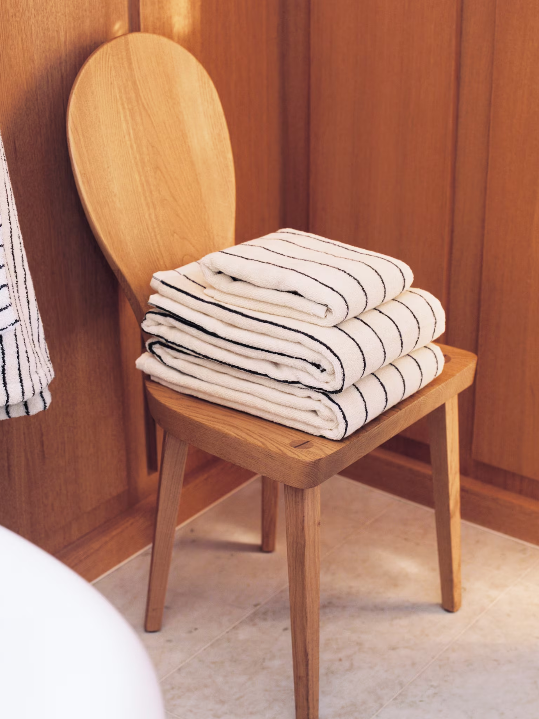 A stack of white and black striped towels from Arket