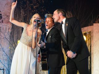 Prince WIlliam singing on stage with Bon Jovi and Taylor Swift at the Winter Whites Centrepoint Gala at Kensington Palace