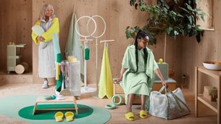 Two people stand among a range of IKEA Dajlien home workout equipment.