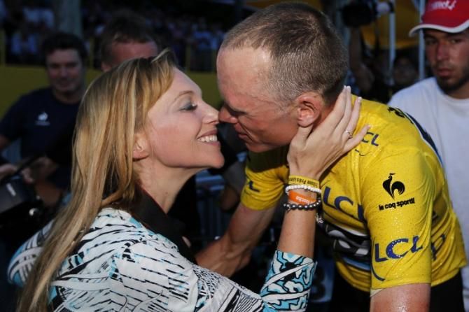 Chris Froome and his fiancee celebrate after the final stage in Paris