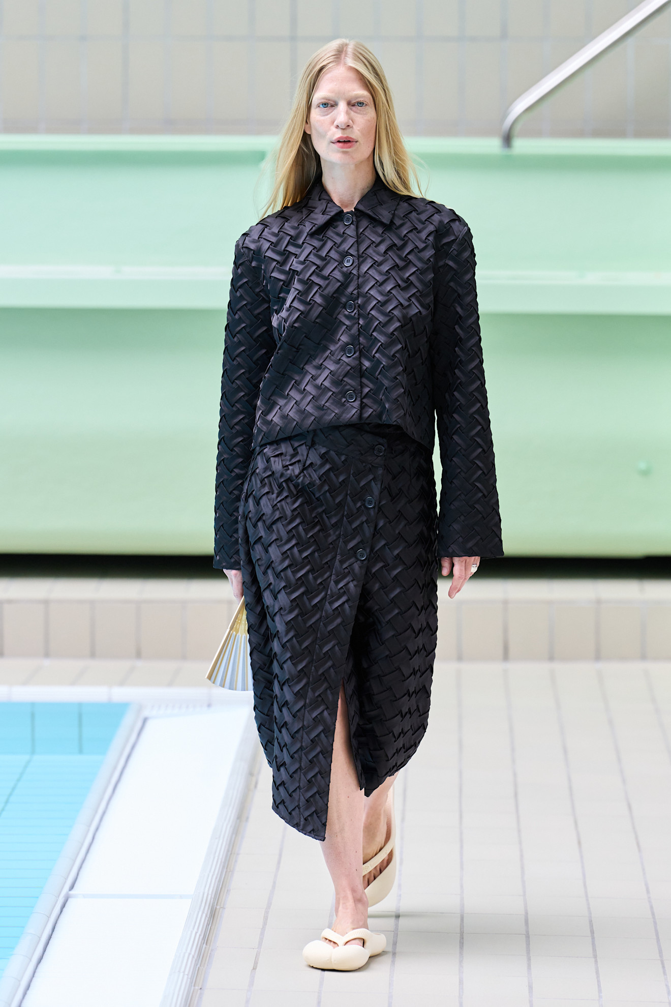 Models wear knitted clothes on the spring and summer 2026 runway.