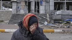 A Ukrainian woman cries after returning to her destroyed neighbourhood in Bucha