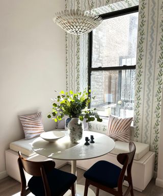 Breakfast nook with a patterned wallpaper and pillows