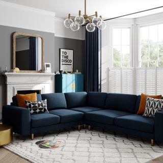 Blue L-shaped sofa with patterned scatter cushions in living room