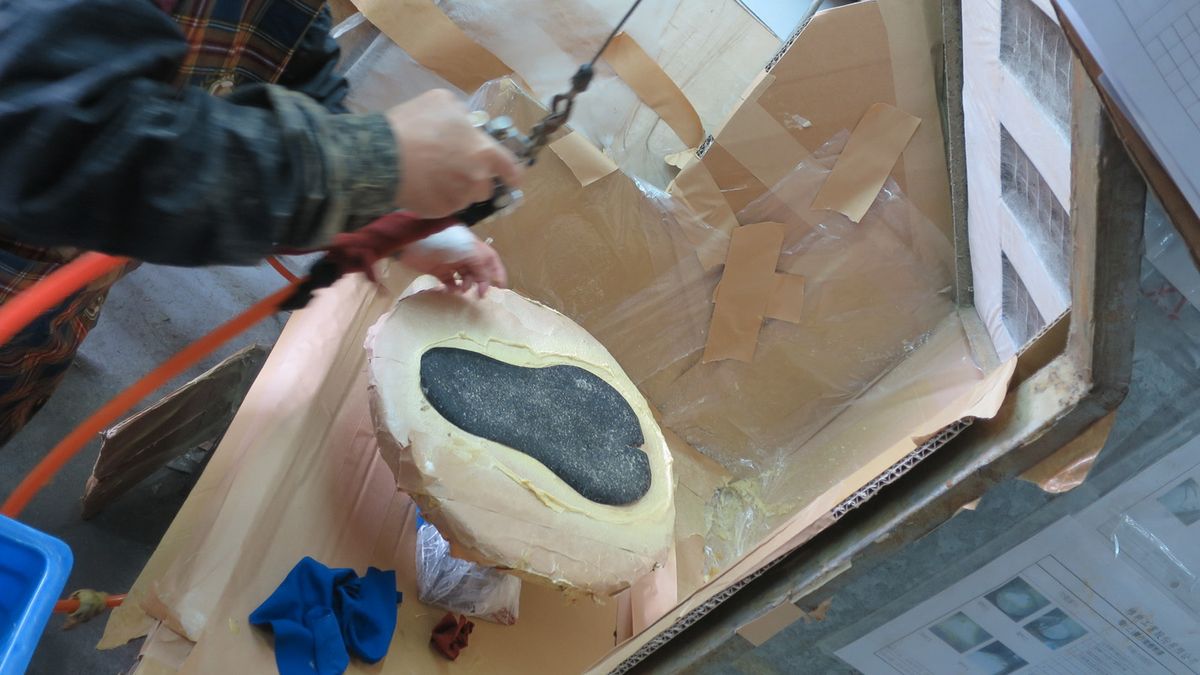 Saddle covers are sprayed with a bonding agent before being set on the pad