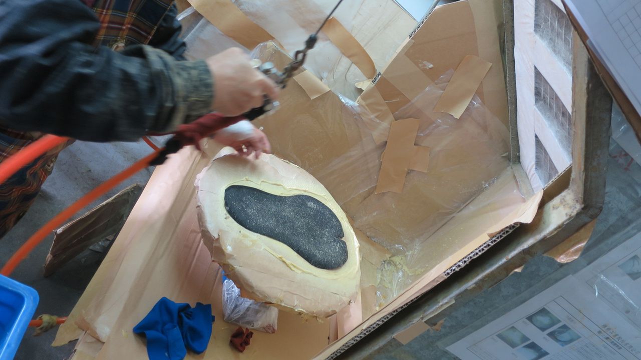 Saddle covers are sprayed with a bonding agent before being set on the pad