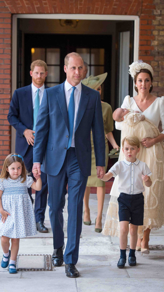 Britain's Princess Charlotte of Cambridge and Britain's Prince George of Cambridge hold hands with their father, Britain's Prince William, Duke of Cambridge, as Britain's Prince Louis of Cambridge is carried by Britain's Catherine, Duchess of Cambridge on their arrival for his christening service at the Chapel Royal, St James's Palace, London on July 9, 2018