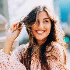best shampoo for dandruff - Woman looking off into the distance with wavy hair gettyimages -636115754