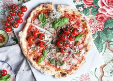 A classic Italian pizza ready to be sliced.